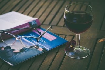 A glass of red wine with a book